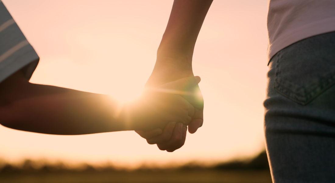 close up of two people holding hands